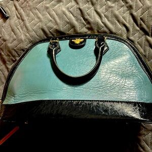 Black and blue handbag tote with gold Bee detail.